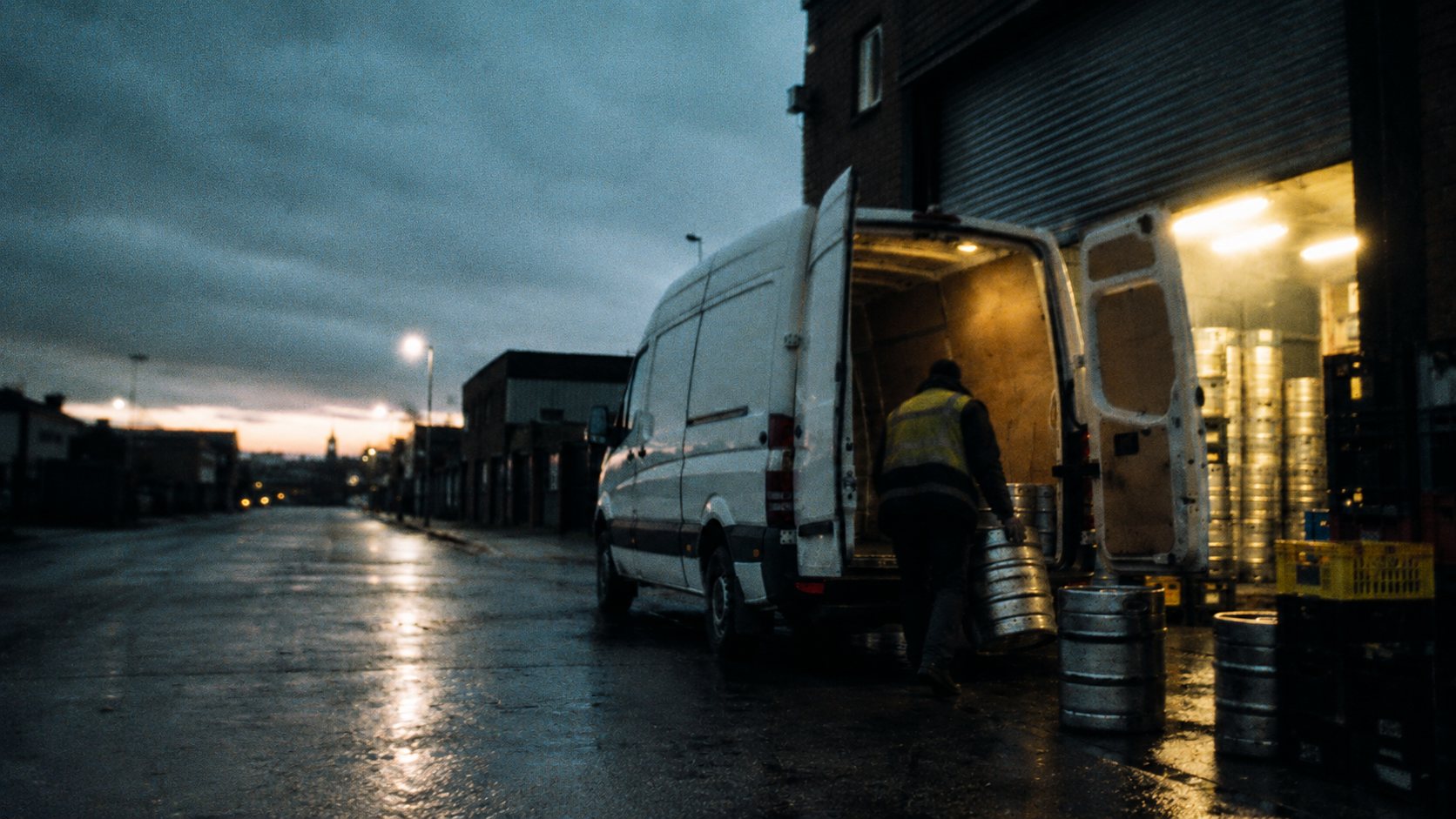 Kegs going into a van at a depot shutter, before six