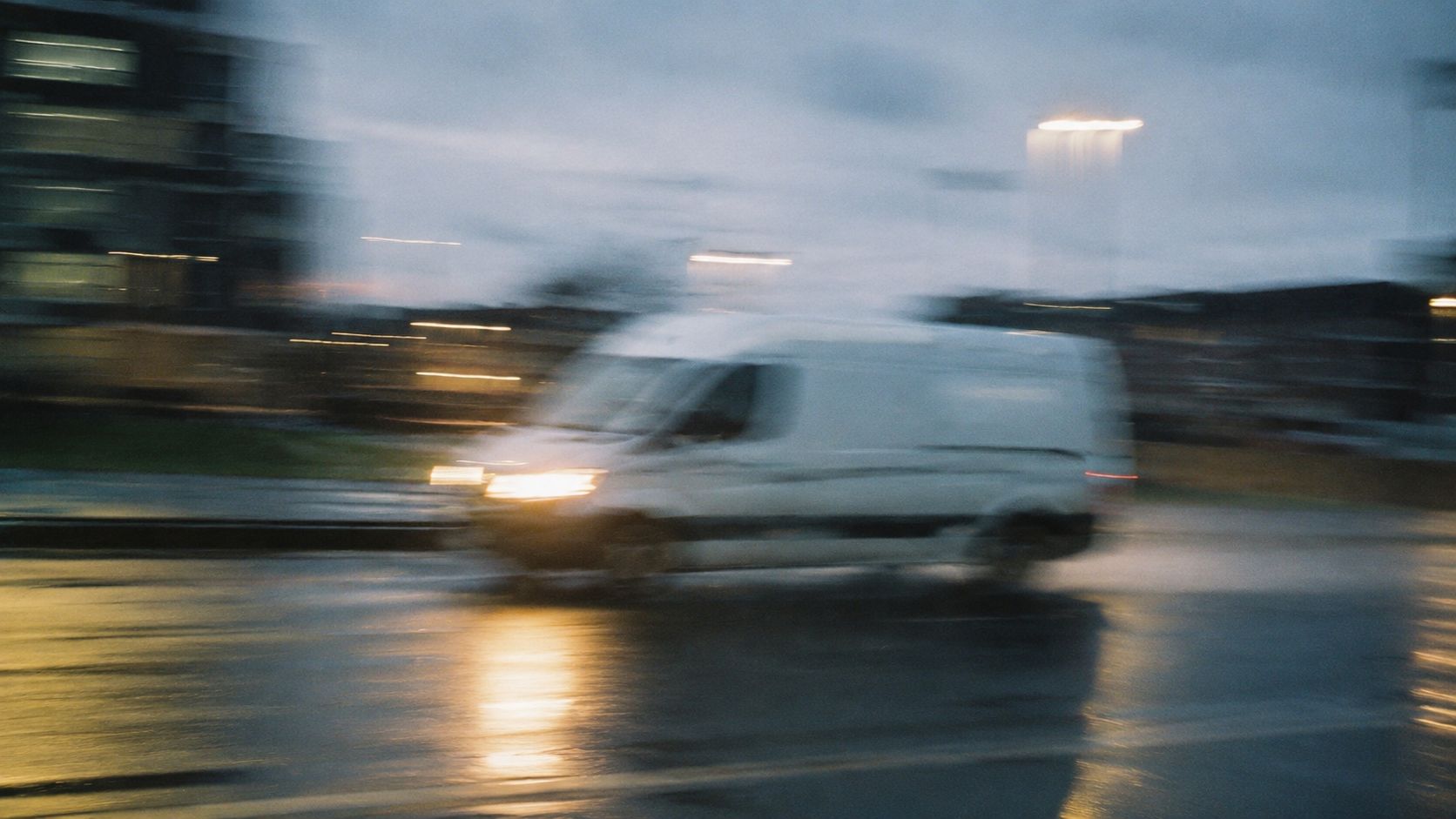 A van cutting through wet Glasgow streets at speed